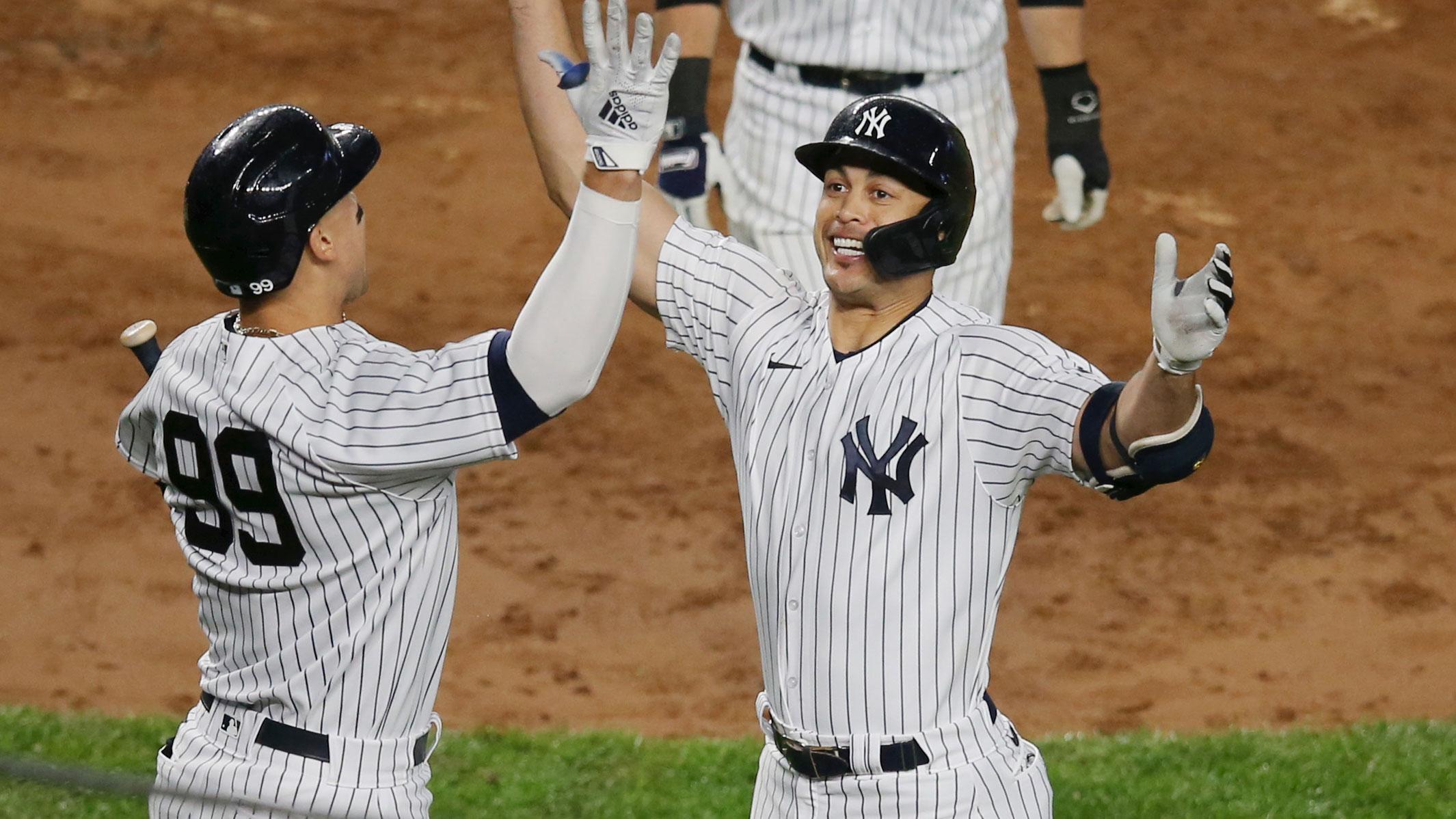 May 5, 2021; Bronx, New York, USA; New York Yankees designated hitter Giancarlo Stanton (27) celebrates with right fielder Aaron Judge (99) after hitting a two run home run against the Houston Astros during the third inning at Yankee Stadium. / Brad Penner-USA TODAY Sports