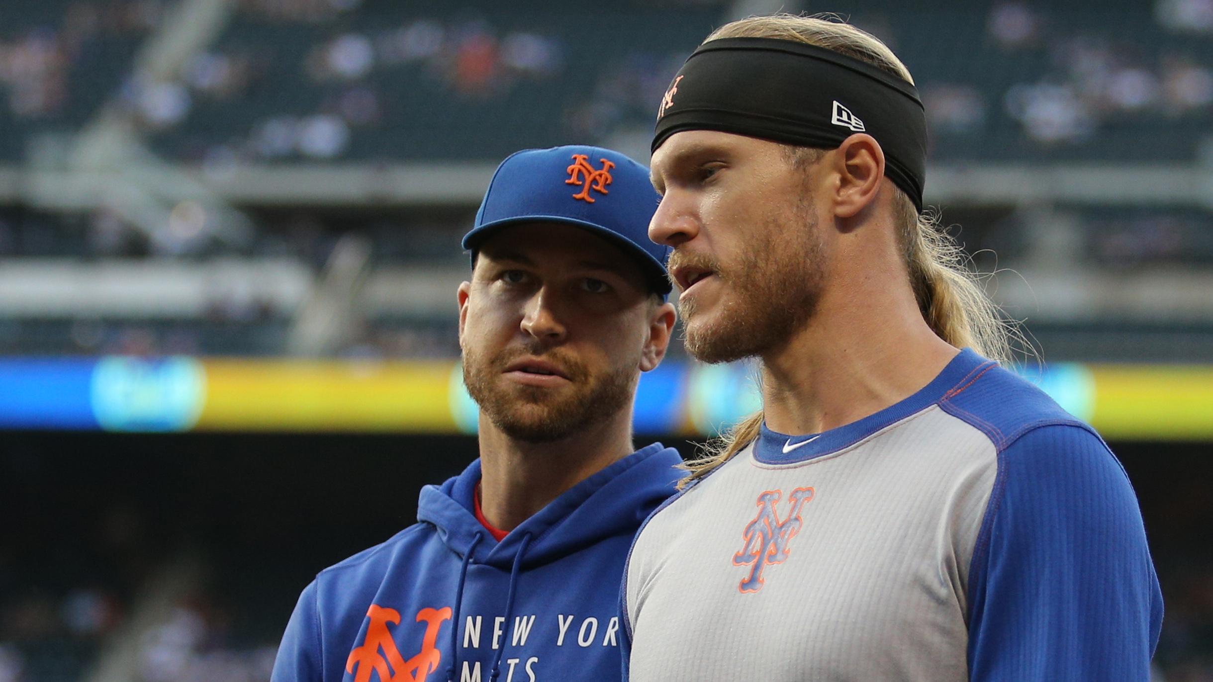 New York Mets injured starting pitchers Jacob deGrom (left) and Noah Syndergaard walk in from the bullpen before a game against the Atlanta Braves at Citi Field. / Brad Penner-USA TODAY Sports