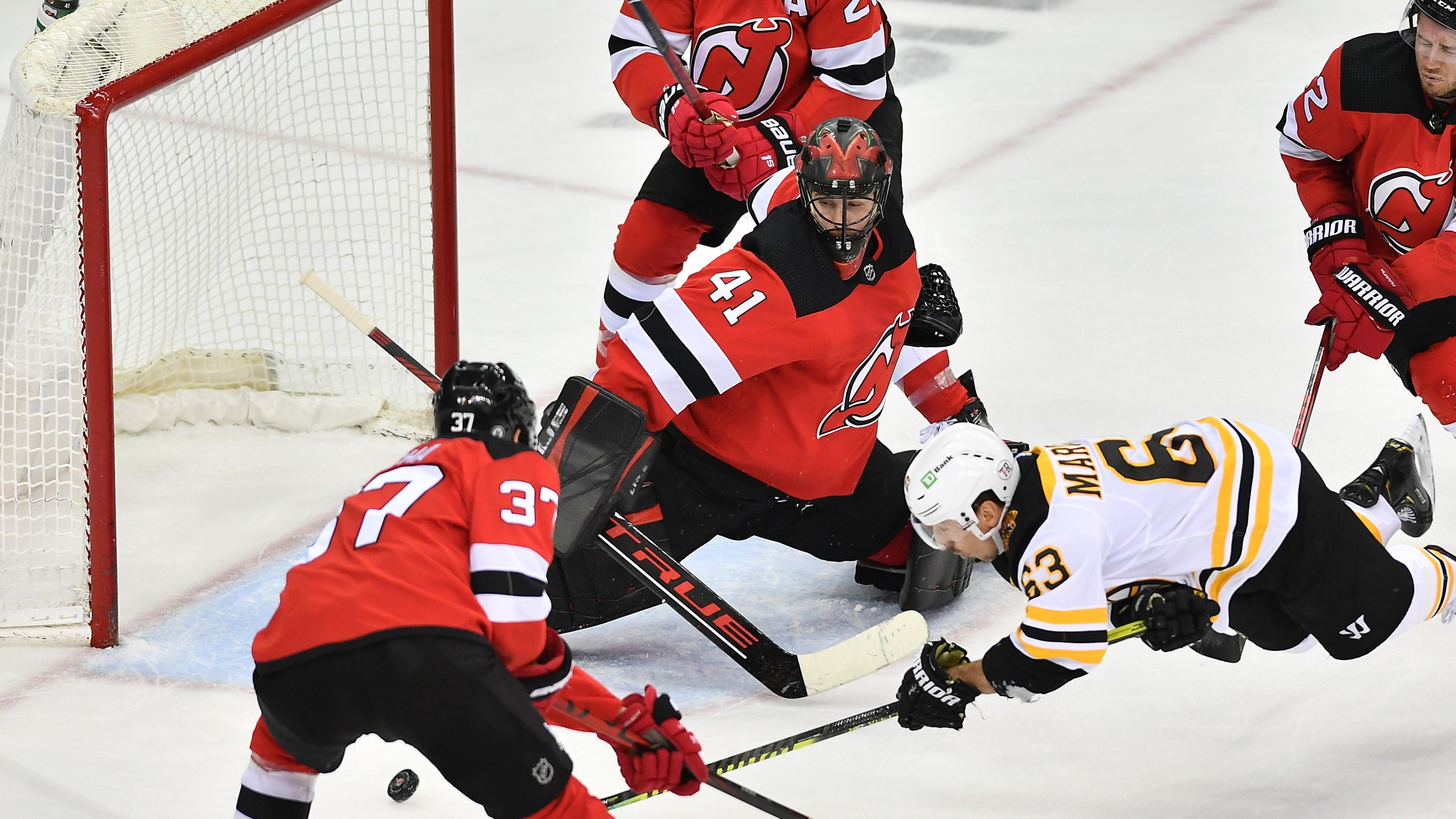 May 3, 2021; Newark, New Jersey, USA; Boston Bruins left wing Brad Marchand (63) takes a shot on goal during his 800th career game against New Jersey Devils goalie Scott Wedgewood (41) during the second period at Prudential Center. Mandatory Credit: Catalina Fragoso-USA TODAY Sports / May 3, 2021; Newark, New Jersey, USA; Boston Bruins left wing Brad Marchand (63) takes a shot on goal during his 800th career game against New Jersey Devils goalie Scott Wedgewood (41) during the second period at Prudential Center. Mandatory Credit: Catalina Fragoso-USA TODAY Sports