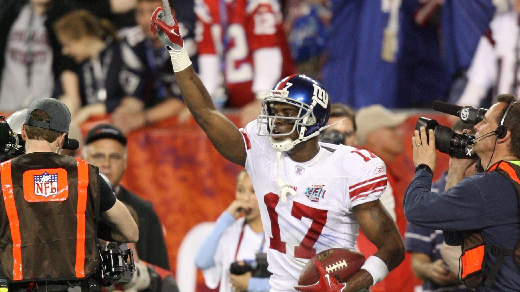 Feb 3, 2008; Glendale, AZ, USA; New York Giants wide receiver Plaxico Burress (17) celebrates catching the game-winning touchdown in the fourth quarter of Super Bowl XLII at the University of Phoenix Stadium. New York Giants defeated the New England Patriots with a final of 17-14. Mandatory Credit: John David Mercer-USA TODAY Sports / John David Mercer-USA TODAY Sports